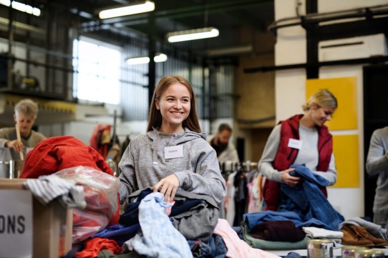 woman sorting donated clothes at a facility